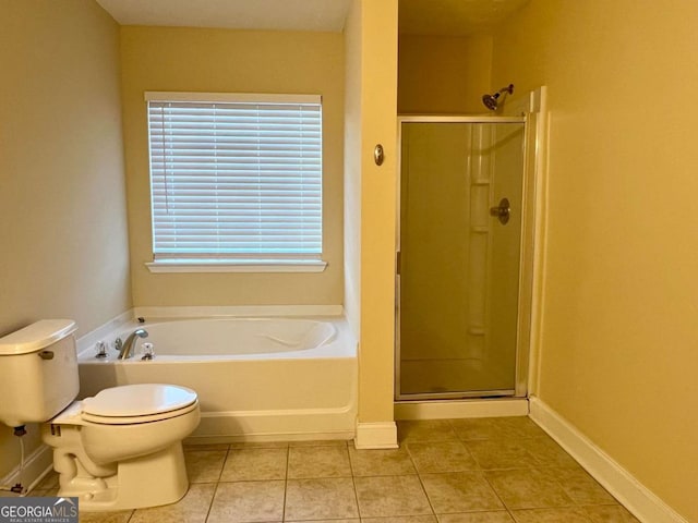 bathroom featuring tile patterned flooring, plus walk in shower, and toilet