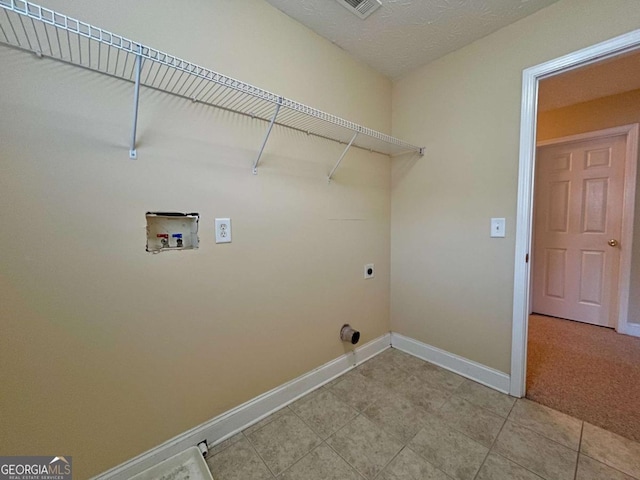 laundry area featuring washer hookup, tile patterned flooring, hookup for an electric dryer, and a textured ceiling