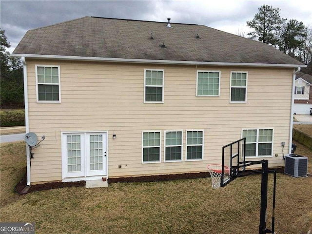 back of house featuring cooling unit and a lawn