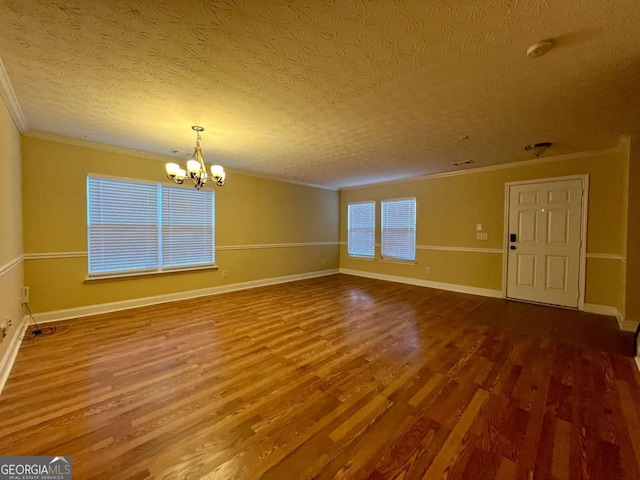 interior space featuring an inviting chandelier, wood-type flooring, and ornamental molding