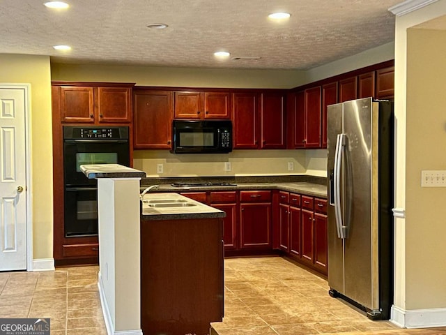 kitchen featuring a textured ceiling, sink, a kitchen island, and black appliances