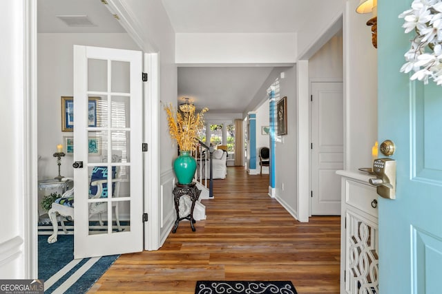 entrance foyer featuring wood finished floors, visible vents, french doors, and baseboards