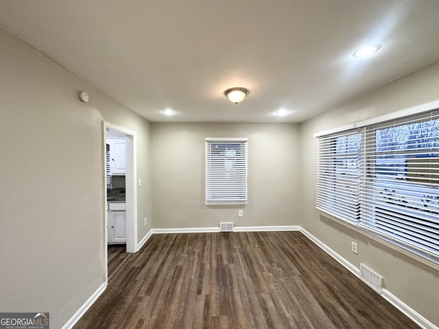 spare room with dark wood-type flooring