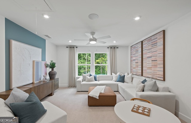 living room with light colored carpet and ceiling fan