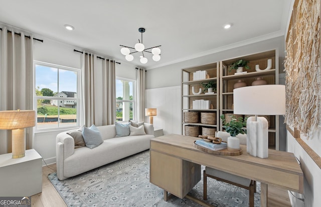 office featuring crown molding, an inviting chandelier, and light hardwood / wood-style floors