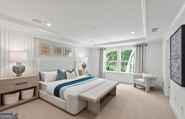 carpeted bedroom with a tray ceiling