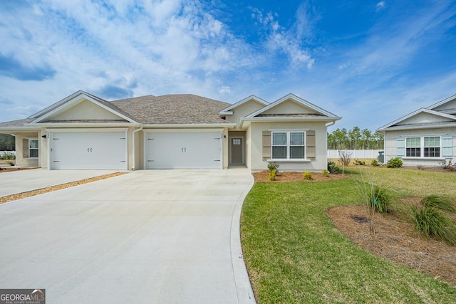 ranch-style house featuring a garage and a front yard