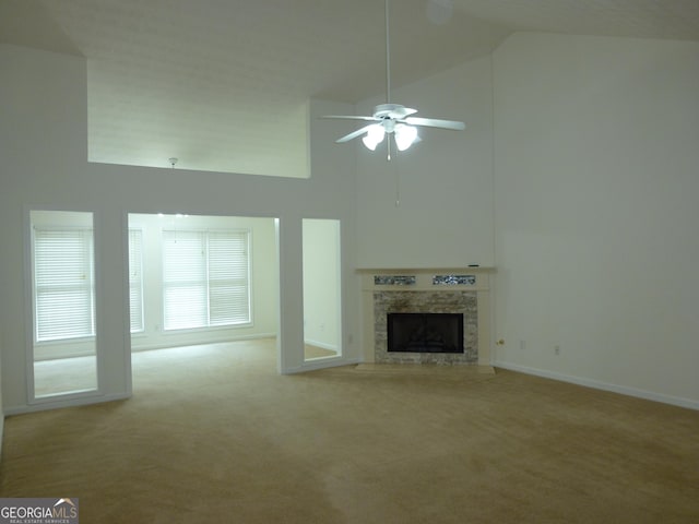 unfurnished living room with light carpet, ceiling fan, a fireplace, and high vaulted ceiling