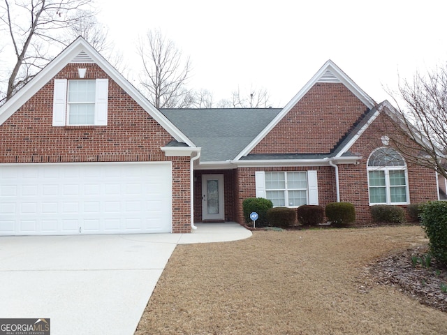 view of front of property featuring a garage and a front lawn