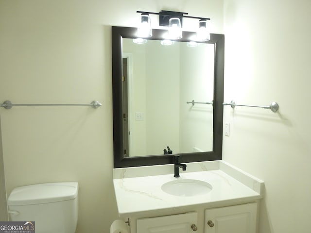 bathroom featuring toilet and vanity