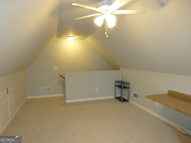 additional living space featuring ceiling fan, lofted ceiling, visible vents, and light colored carpet