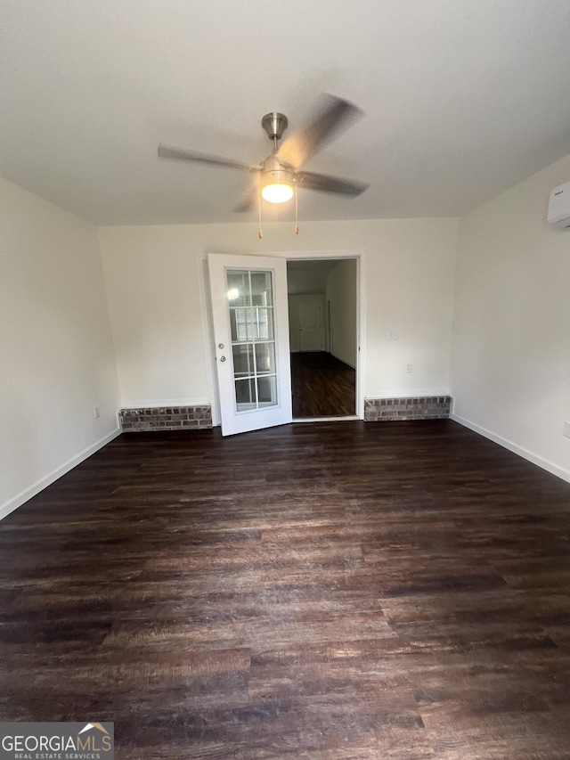 empty room featuring ceiling fan and dark hardwood / wood-style flooring