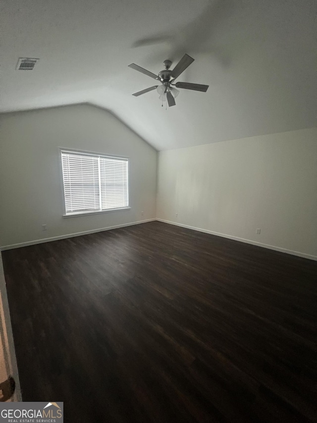 bonus room with vaulted ceiling, ceiling fan, and dark hardwood / wood-style flooring