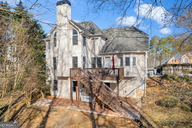 rear view of property with a wooden deck