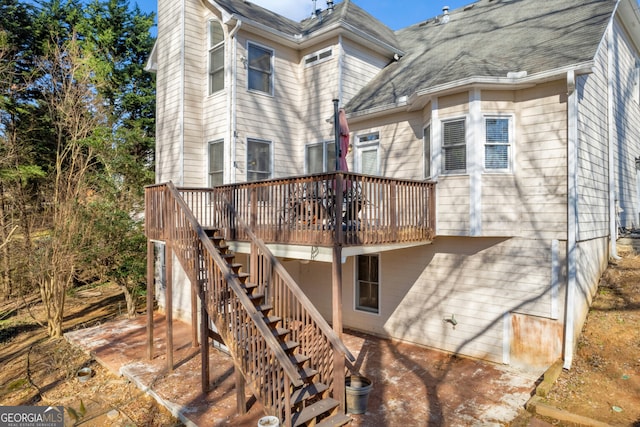 view of side of home with a wooden deck