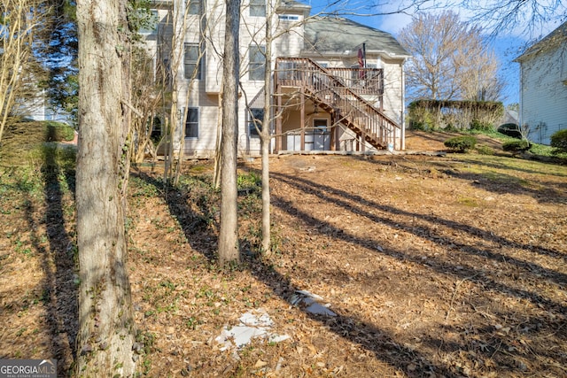 back of property featuring a wooden deck