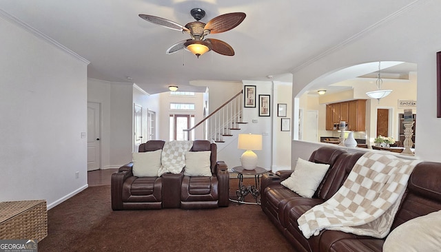 living room featuring ornamental molding, carpet floors, and ceiling fan