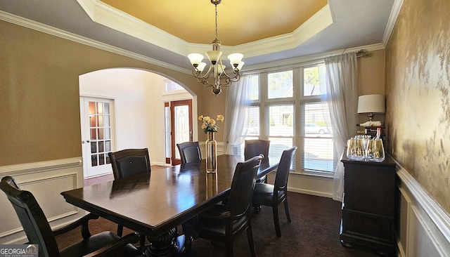 dining space with french doors, ornamental molding, a chandelier, and a tray ceiling