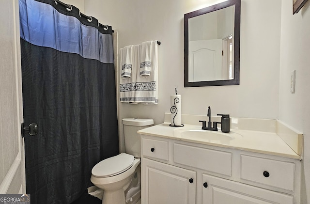 bathroom with a shower with curtain, vanity, and toilet