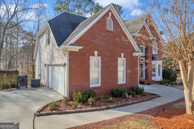 view of front of home featuring a garage and central AC unit