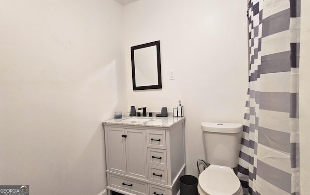 bathroom with vanity, a shower with curtain, and toilet