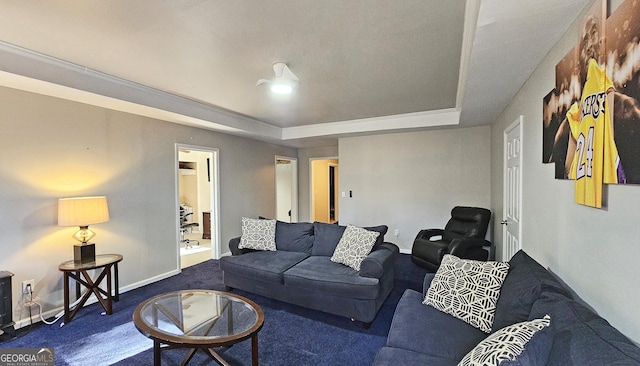 living room with a raised ceiling and carpet flooring