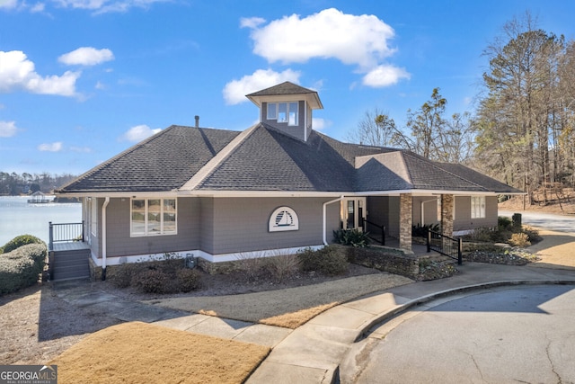 view of front facade with a water view and covered porch