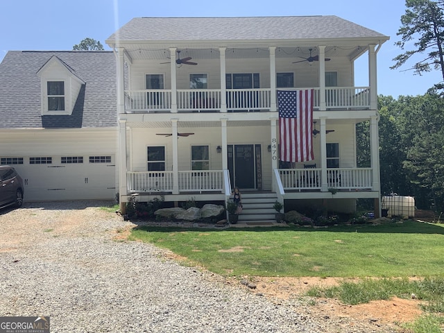 view of front facade with an attached garage, a porch, gravel driveway, and a balcony