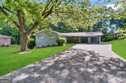 ranch-style home featuring a carport and a front lawn