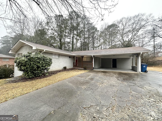3403 Dodson Ter, East Point, GA 30344 - ranch-style house with driveway, an attached carport, and stucco siding