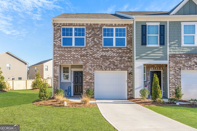 townhome / multi-family property featuring a garage and a front yard