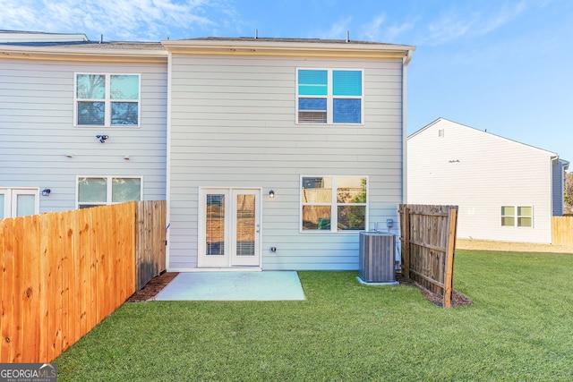 back of property with a patio, a yard, and central AC unit