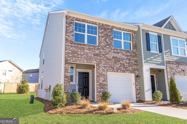 view of property with a garage and a front lawn