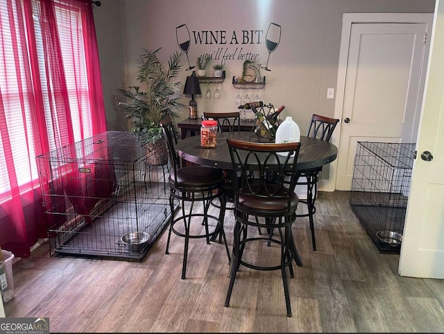 dining space with hardwood / wood-style flooring