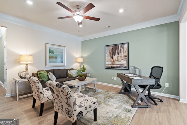 home office featuring crown molding, ceiling fan, and light hardwood / wood-style flooring