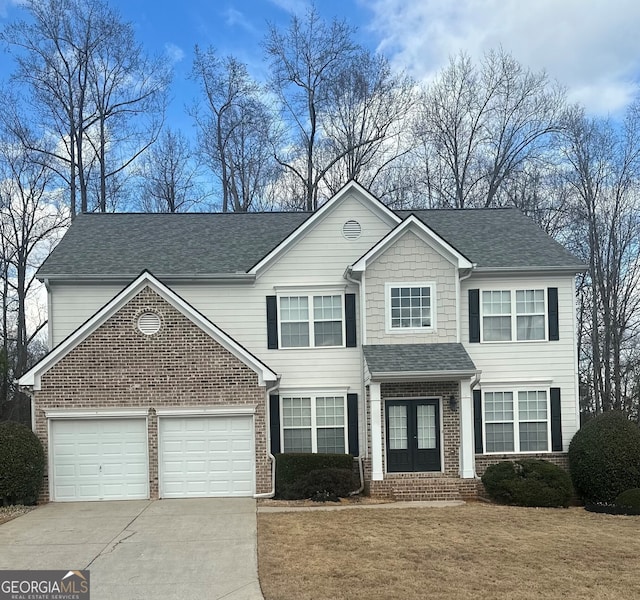 view of front property with a garage and a front yard