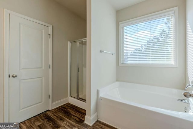 bathroom with plus walk in shower and hardwood / wood-style floors