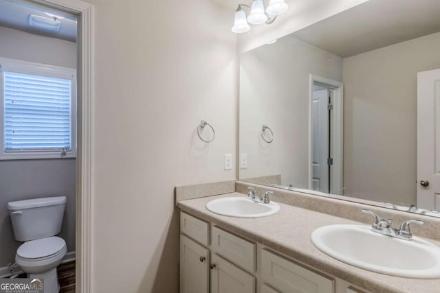 bathroom featuring vanity and toilet