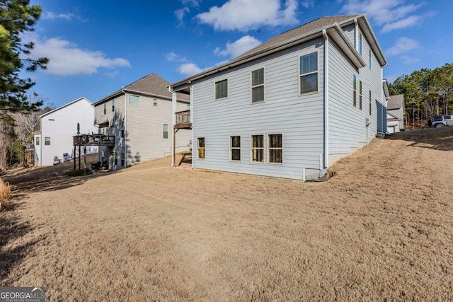 back of property featuring a balcony