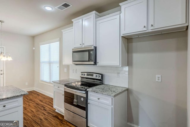 kitchen with appliances with stainless steel finishes, tasteful backsplash, white cabinetry, hanging light fixtures, and light stone counters