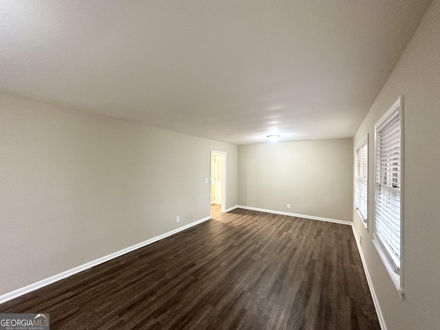 spare room with dark hardwood / wood-style floors