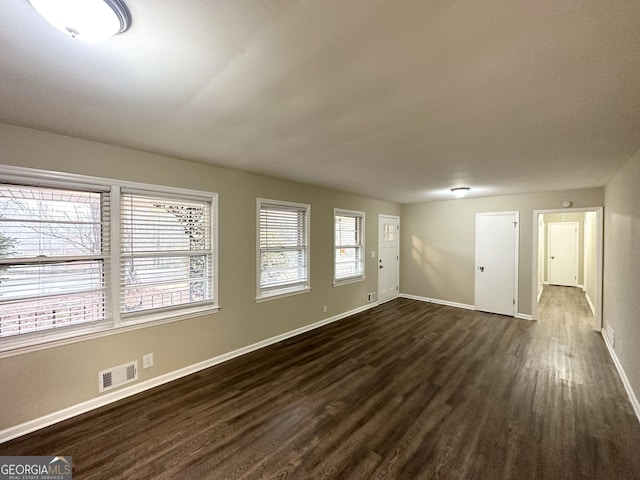 unfurnished room featuring dark hardwood / wood-style floors