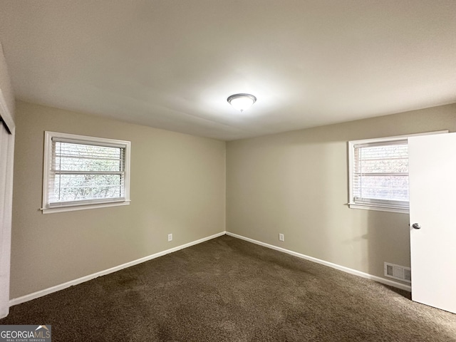 carpeted empty room with a healthy amount of sunlight