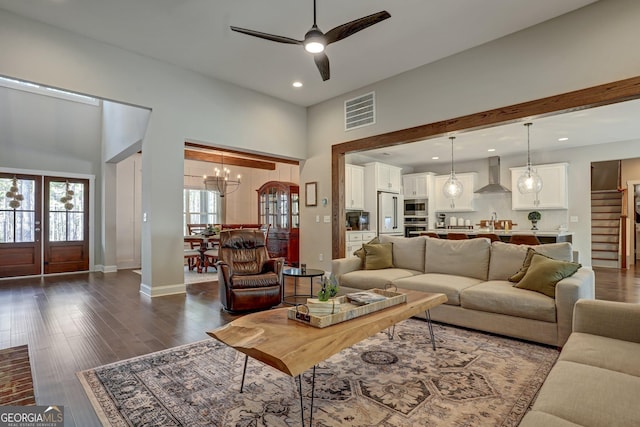 living room with ceiling fan with notable chandelier, sink, and dark hardwood / wood-style floors