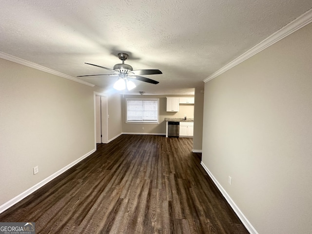 interior space with sink, ceiling fan, dark hardwood / wood-style floors, ornamental molding, and a textured ceiling