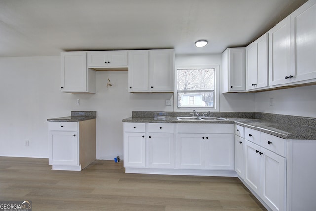 kitchen with white cabinetry and sink