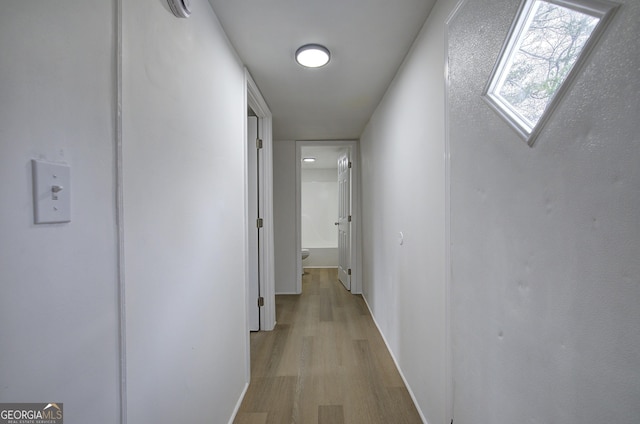 hallway with light hardwood / wood-style flooring