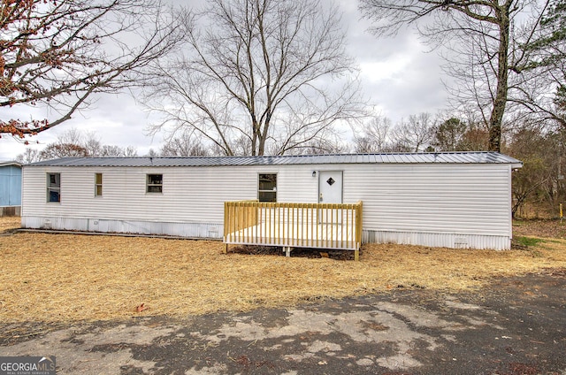 back of house featuring a deck