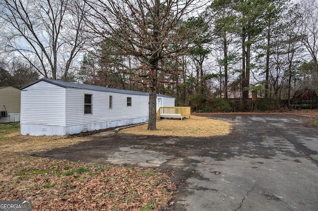 view of property exterior with a deck