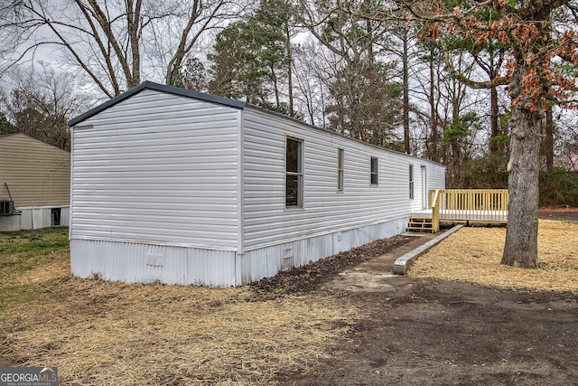 view of side of property with a wooden deck and central air condition unit